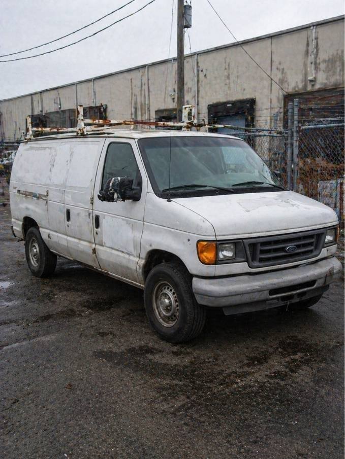 Ford E-350 work van in dirty white paint for cash sale to Milwaukee junk car buyer