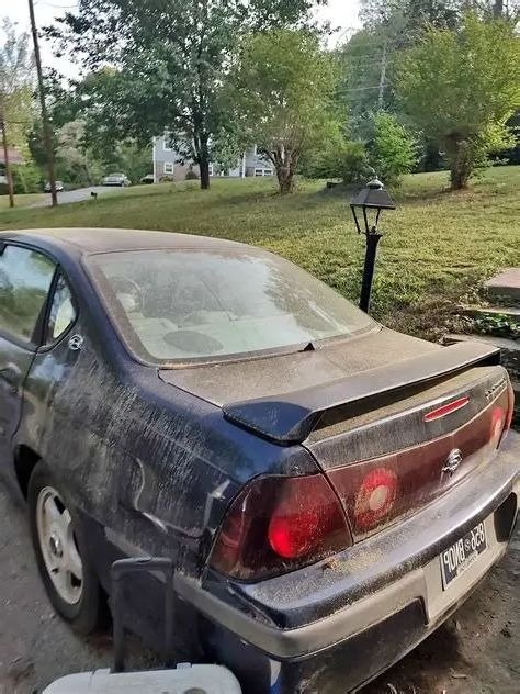 Junk sedan removed from a Milwaukee driveway